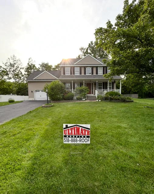 Clifton Park NY — new roof on a two-story colonial home at golden hour — Ultimate Roofing
